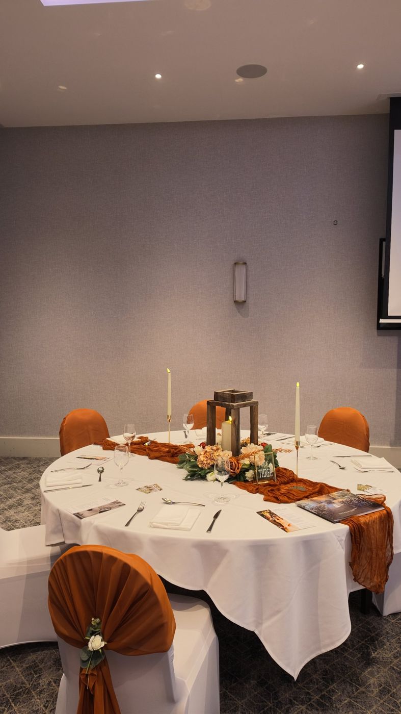 Autumn table with rust runner, lantern and gold candlesticks