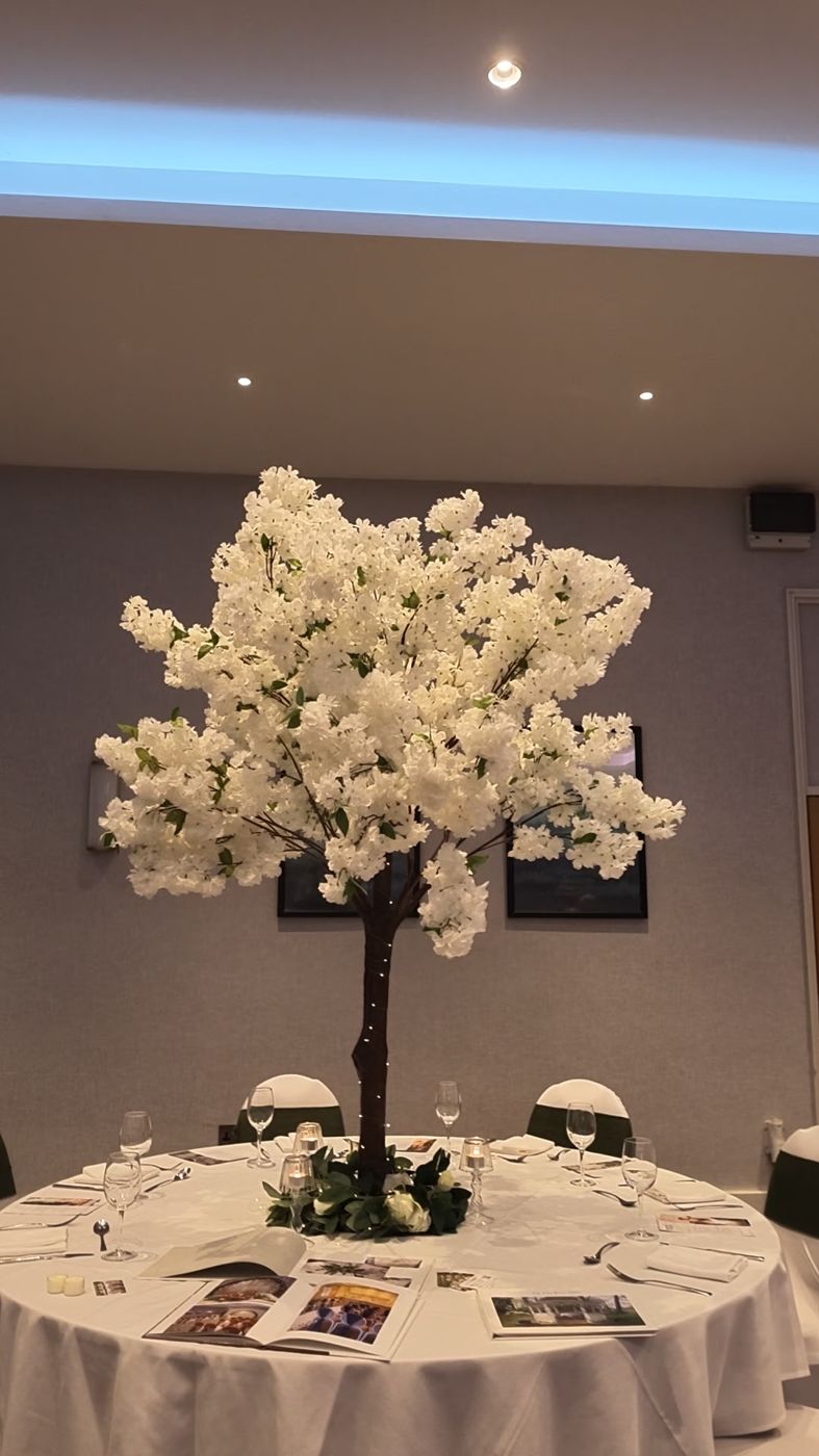 White blossom tree centrepiece on a round table