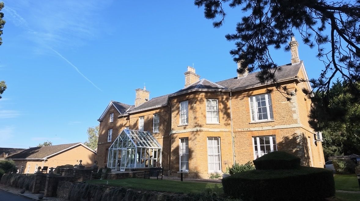 Honey-stone country house venue on a sunny day